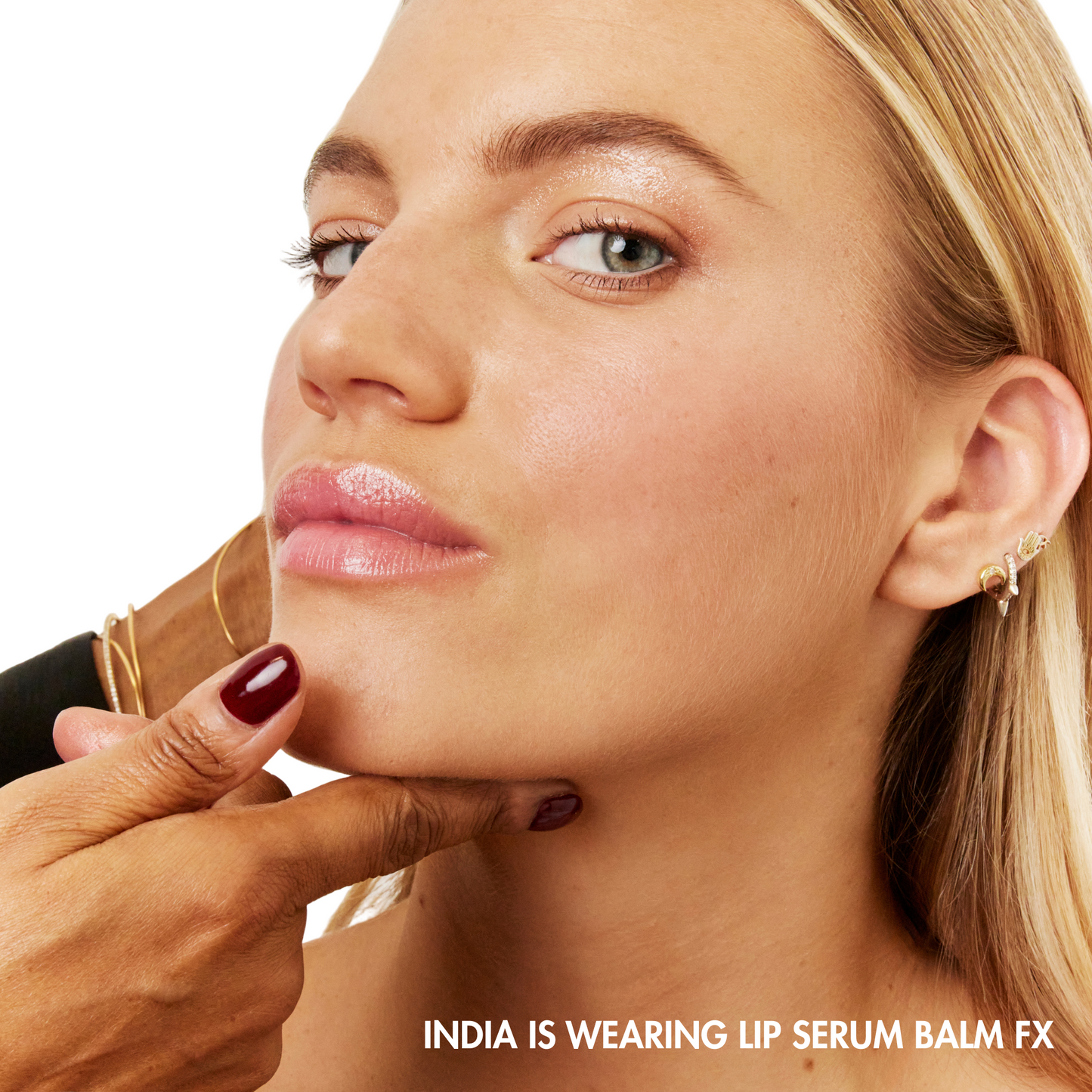 Woman applying lip serum balm with text indicating product name