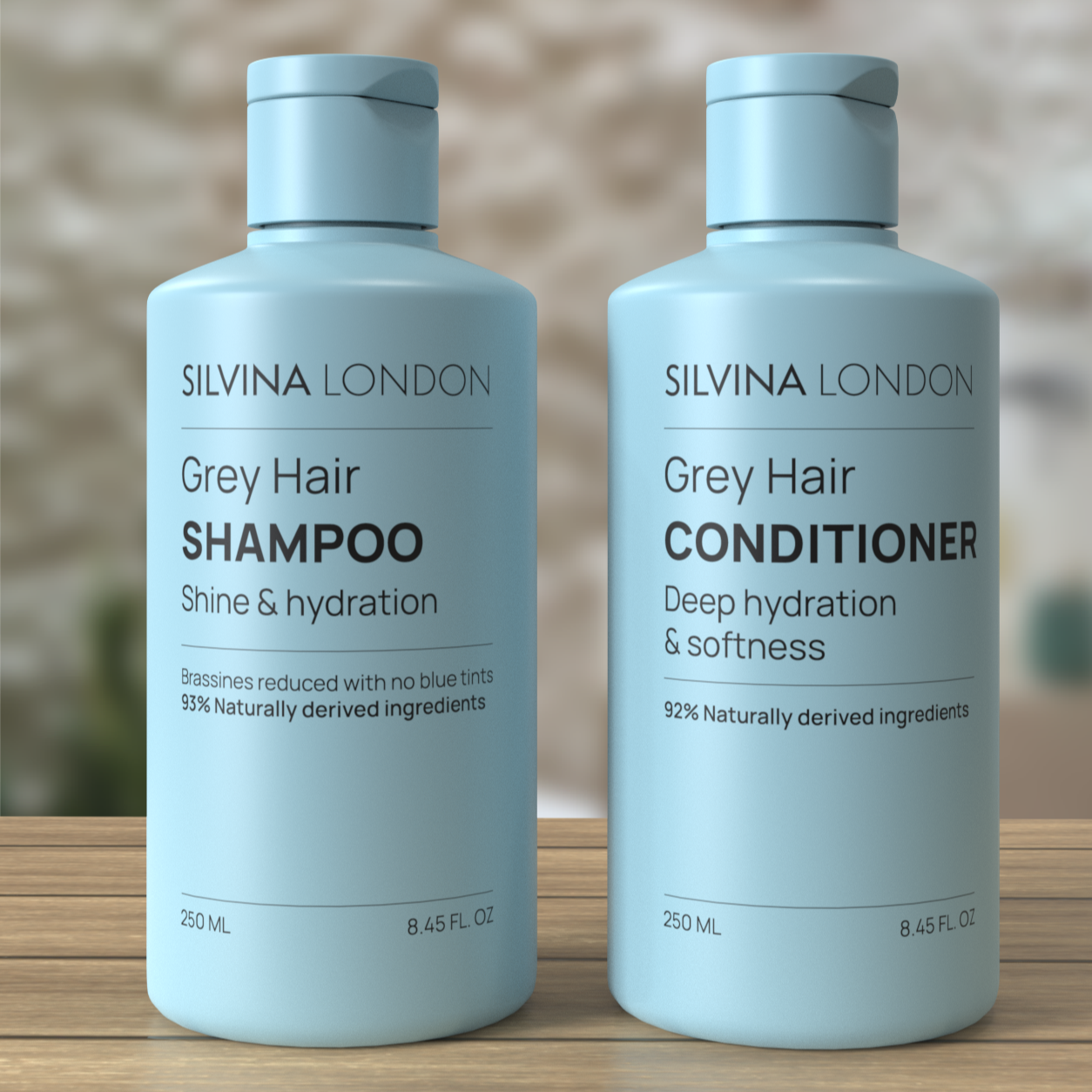 Two bottles of Silvina London Grey Hair Shampoo and Conditioner on a wooden surface with a blurred background.