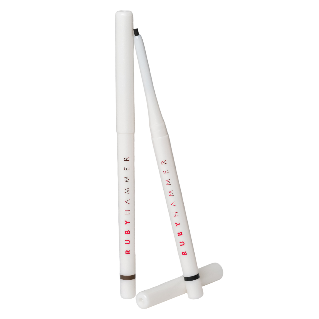 Two white Ruby Hammer drumsticks on a gray background