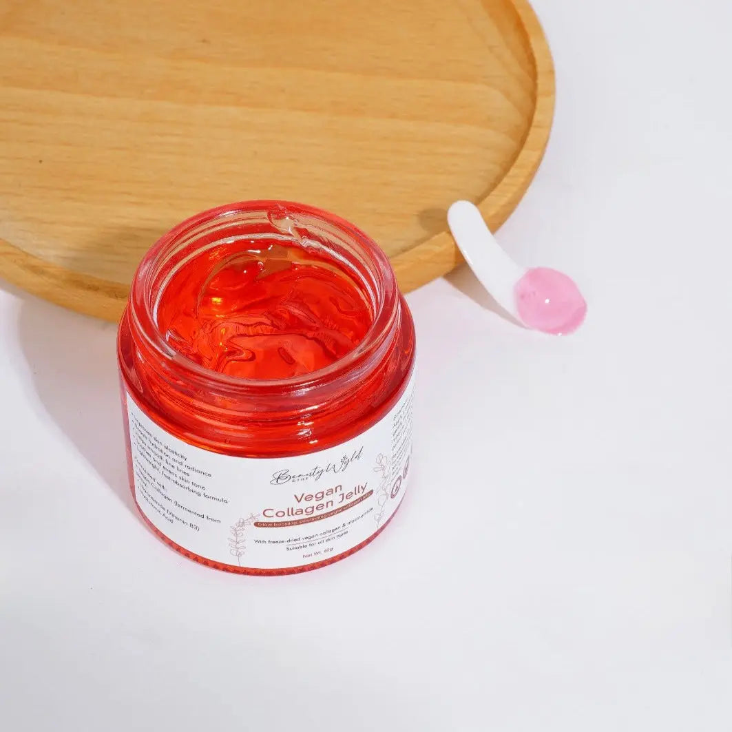 Jar of red gel with a applicator on a white background