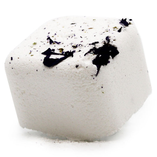 White bath bomb with black specks on a white background