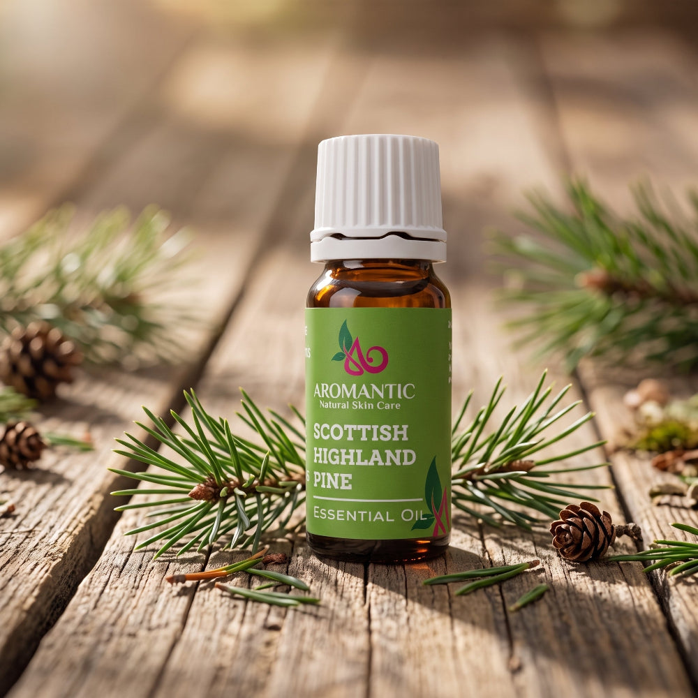 A bottle of Aromantic 100% pure Scottish Highland Pine Essential Oil resting on a rustic wooden table surrounded by fresh pine needles and natural pinecones.