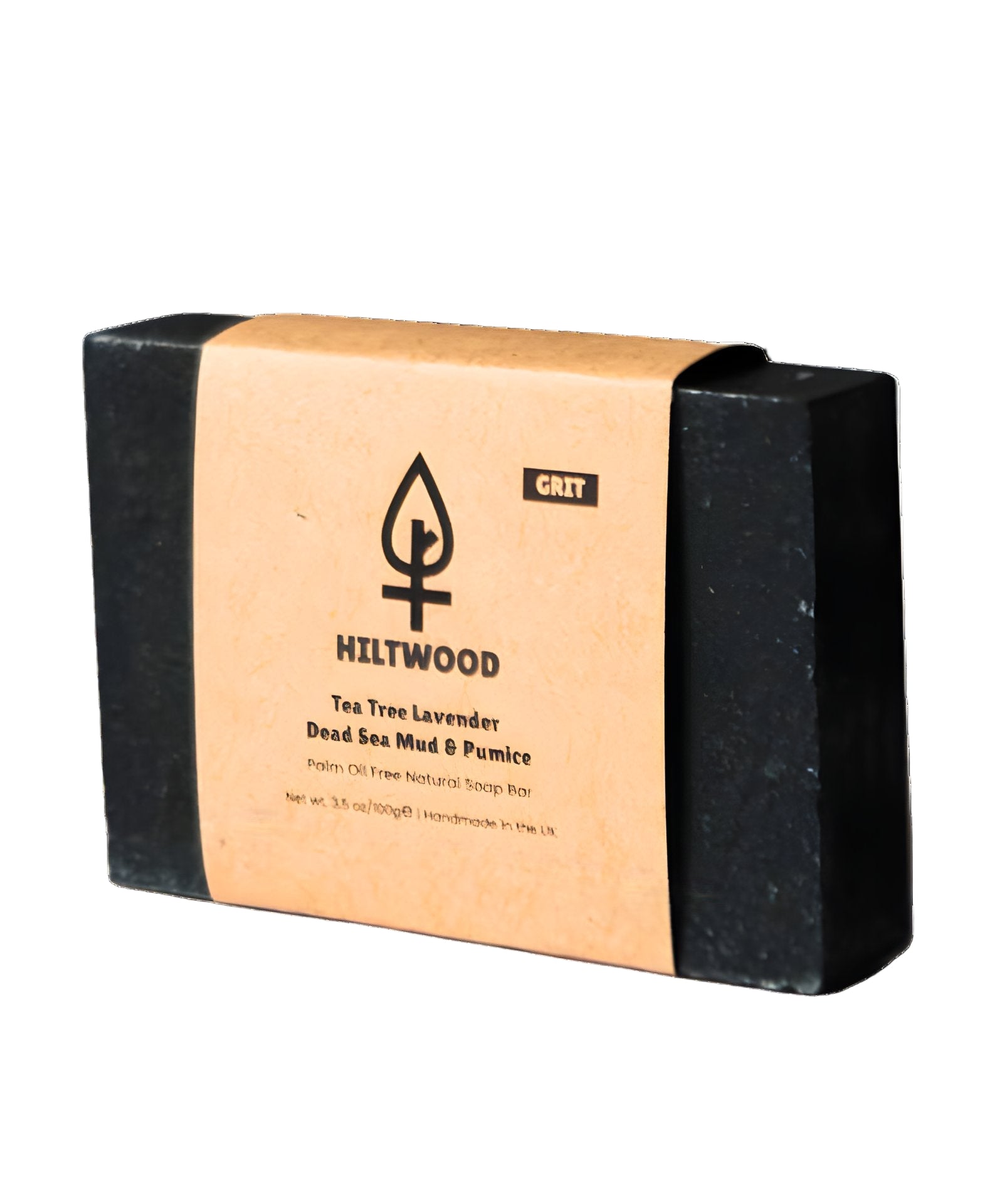Black soap bar with a cardboard packaging label on a gray background
