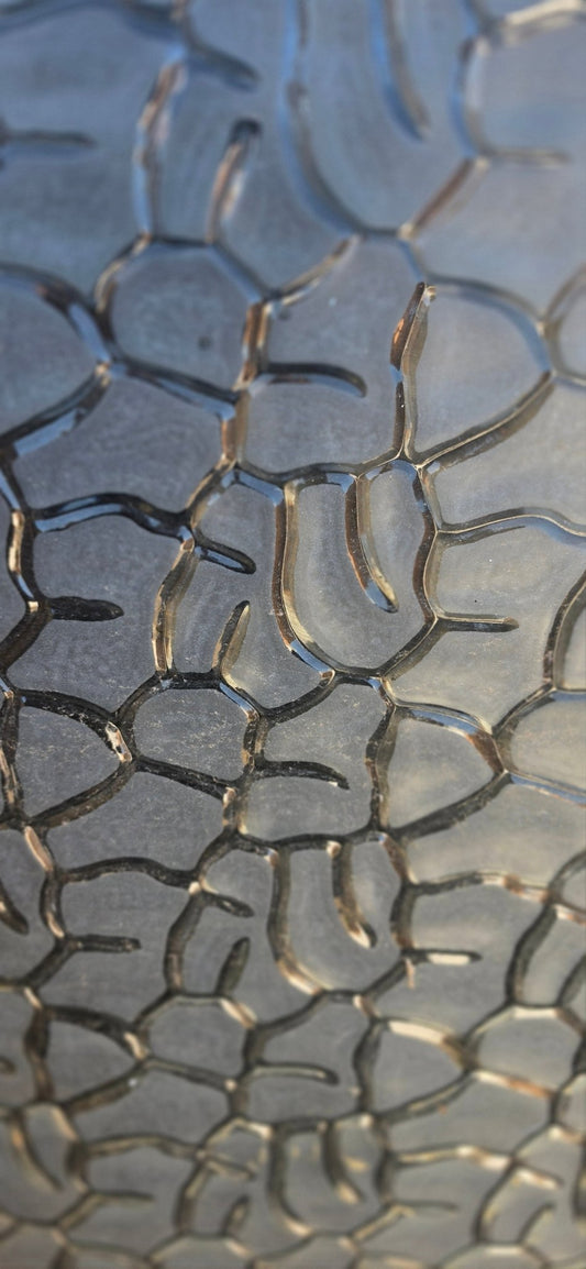 Full view of the obscure glass panel outdoors, showcasing its organic, flowing pattern in natural daylight.