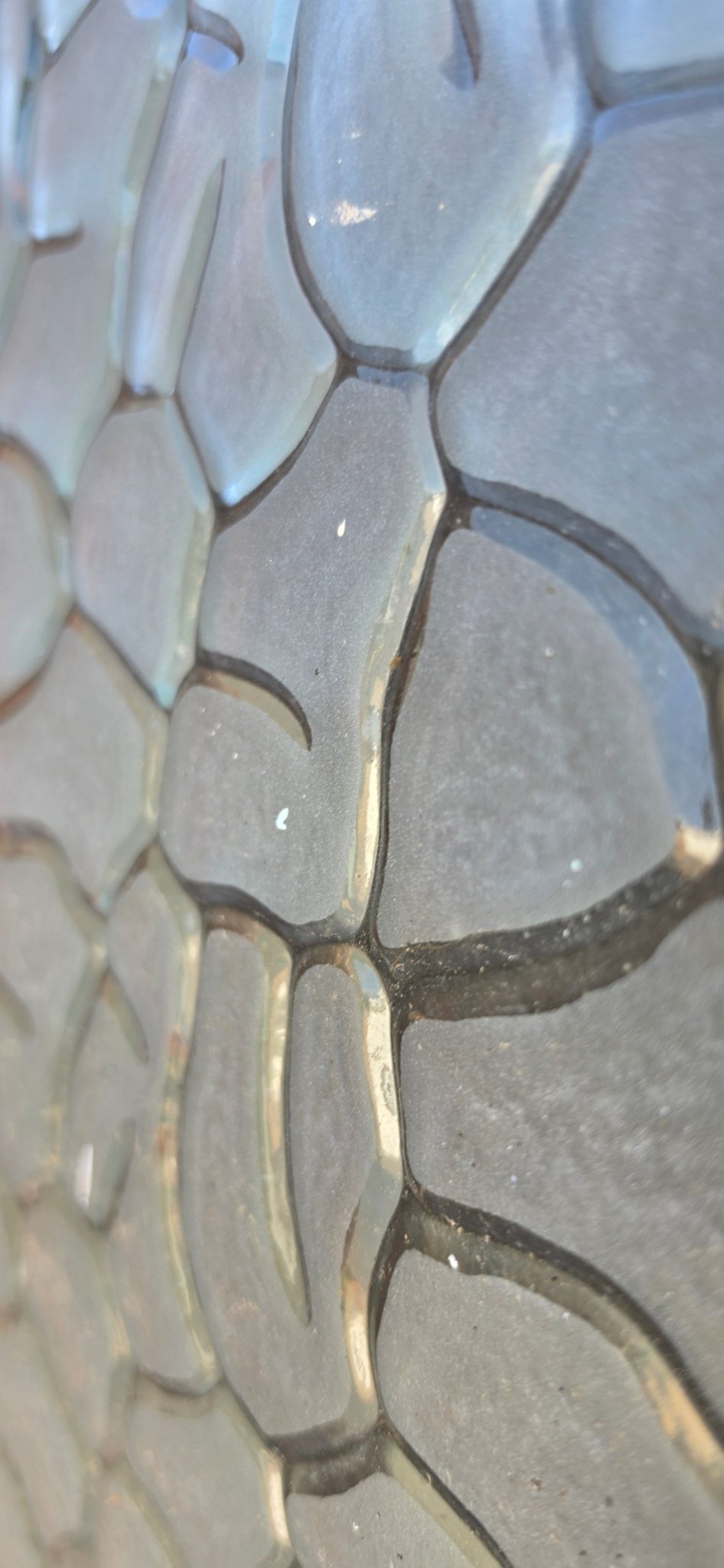 Micro view of the glass surface, focusing on the frosted texture inside individual segments of the pattern.