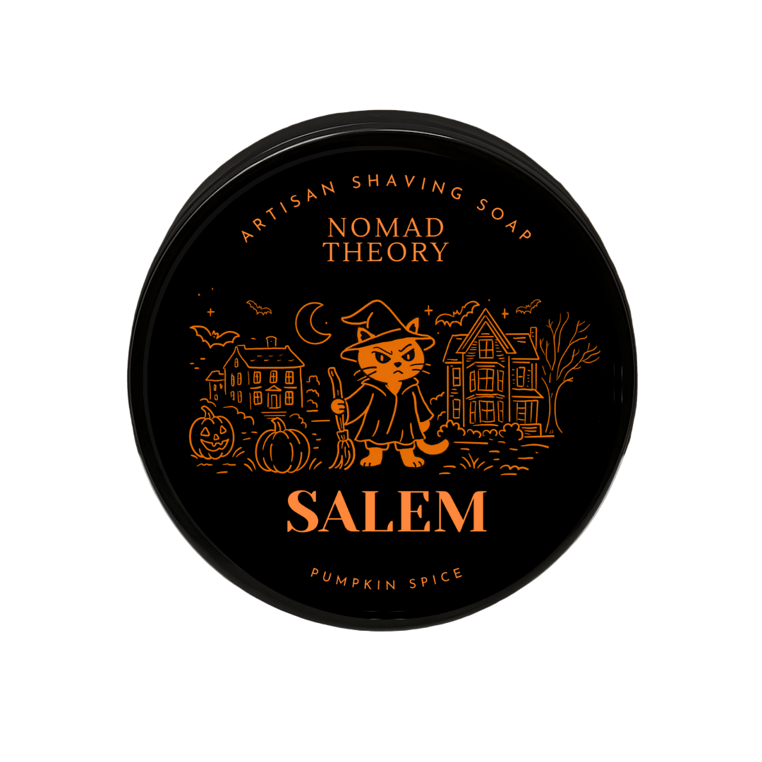 Nomad Theory Salem Pumpkin Spice shaving soap container on a marble surface with a dark background